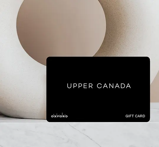 Black Upper Canada Plus gift card against a beige sculpture on marble