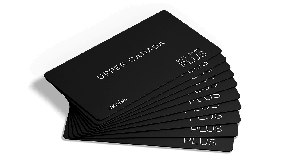 Fanned-out stack of black Upper Canada Plus gift cards on white