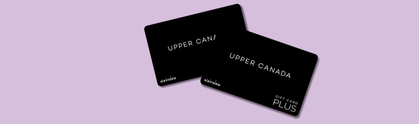 Two black Upper Canada Plus gift cards overlapping on a lilac background