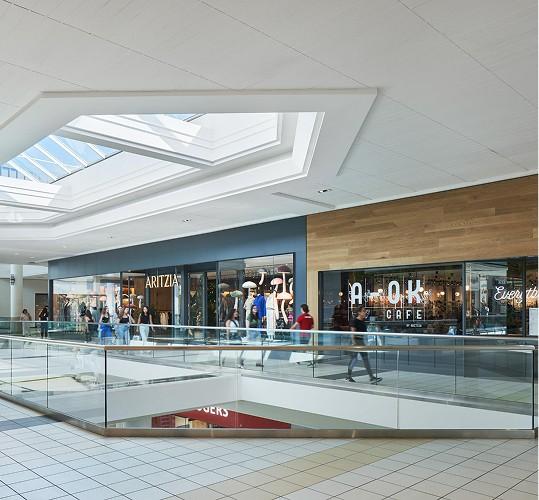Upper-level mall walkway under skylights near Aritzia and A-OK Cafe