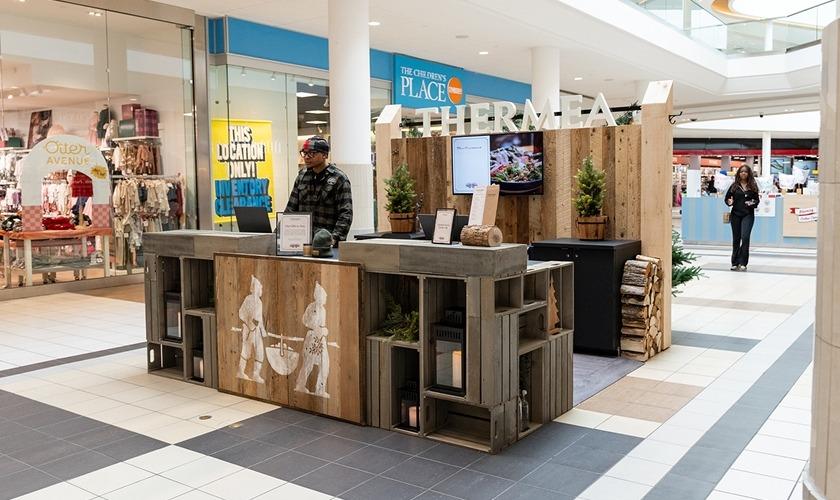 Wooden Thermea pop-up kiosk in the mall near The Children's Place
