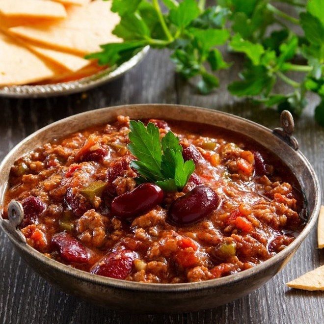 A bowl of chilli from Ma's Best sits on a table.