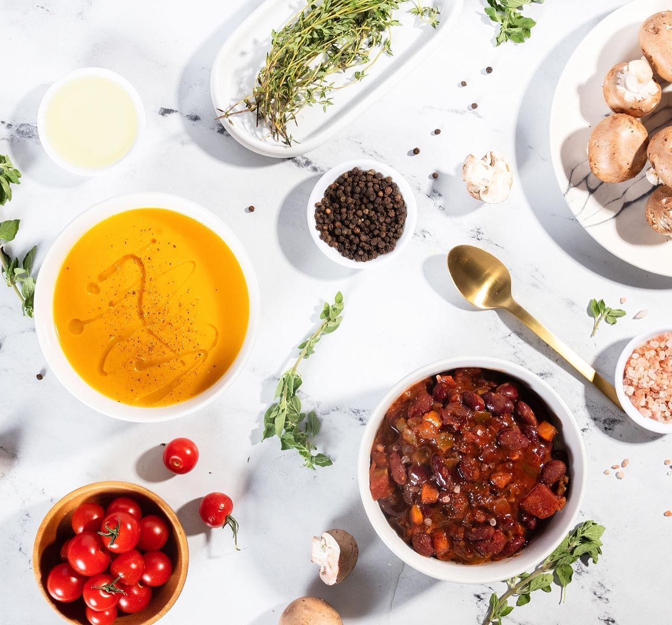 Various soup ingredients are laid out in a flat lay to showcase Ma's Best soups.