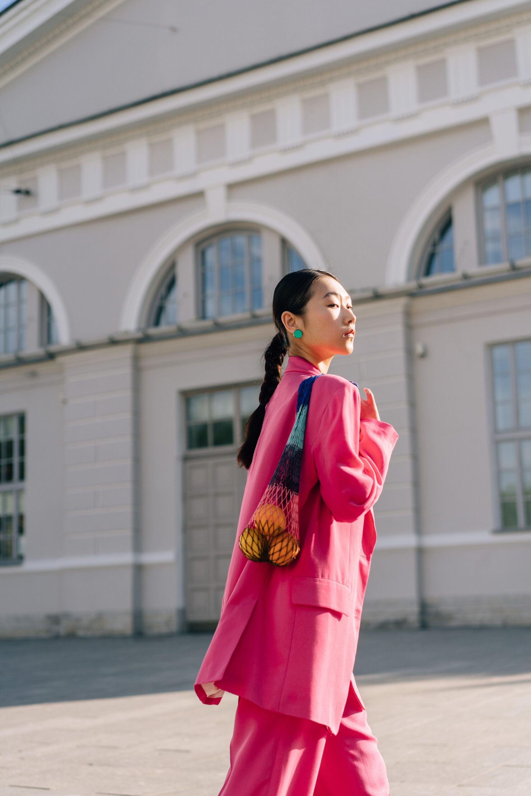 Woman in pink blazer wearing tote bag