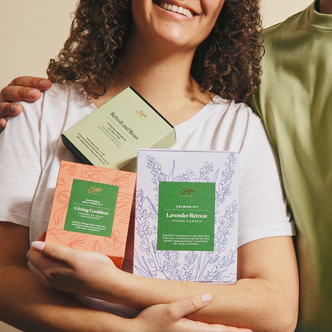 Woman holding 3 Saje boxes