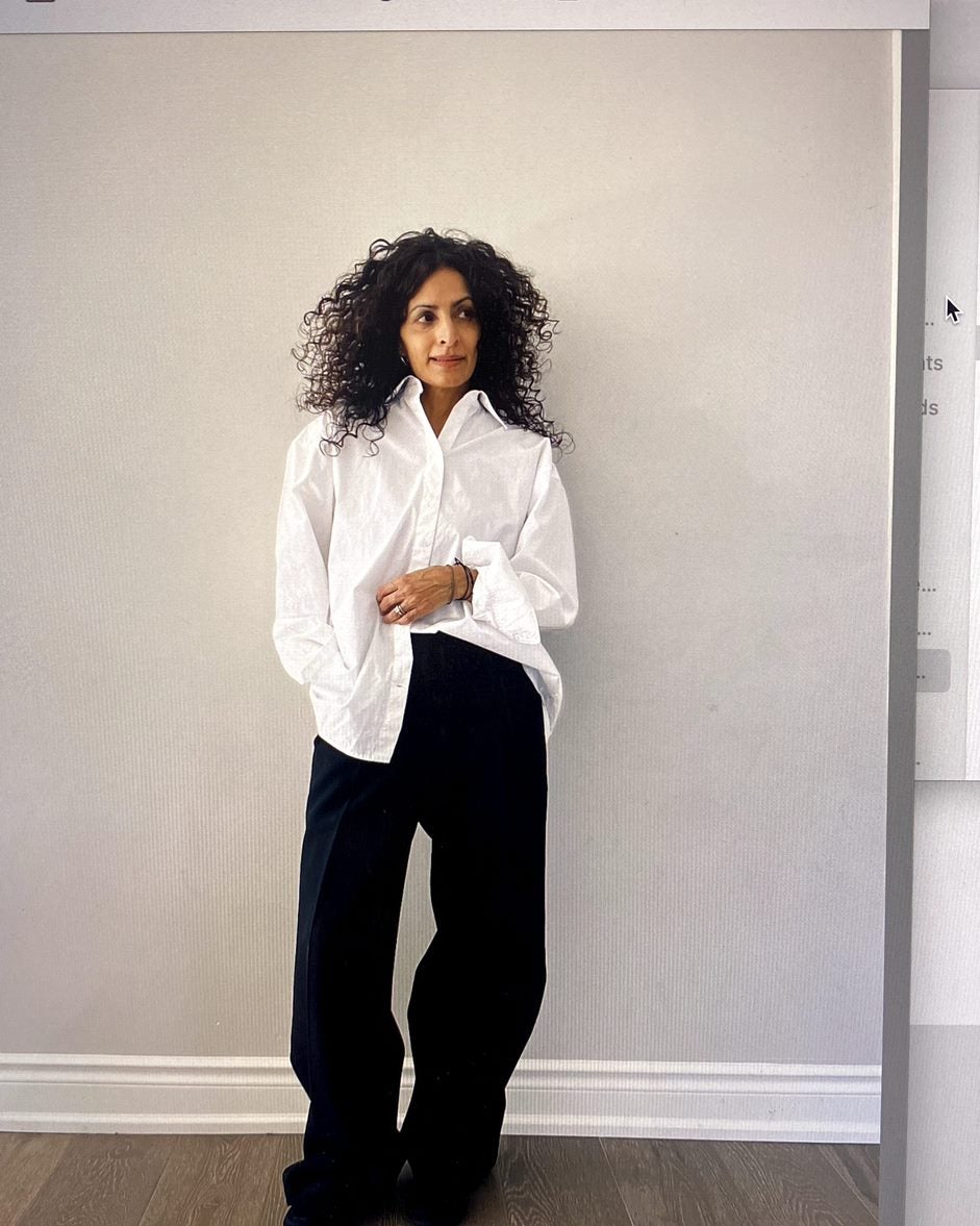 Woman wearing a white shirt and black slacks