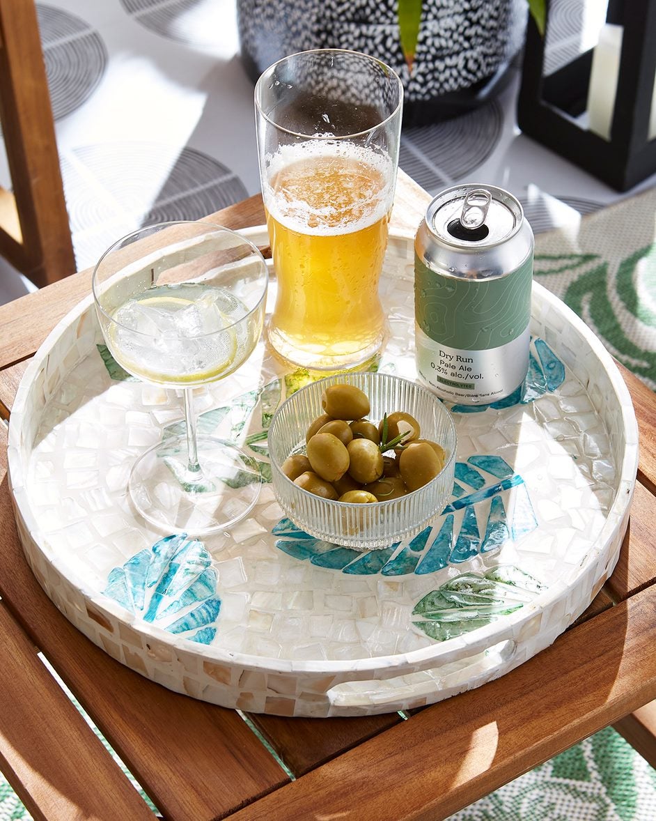 A beverage and a glass on a tray