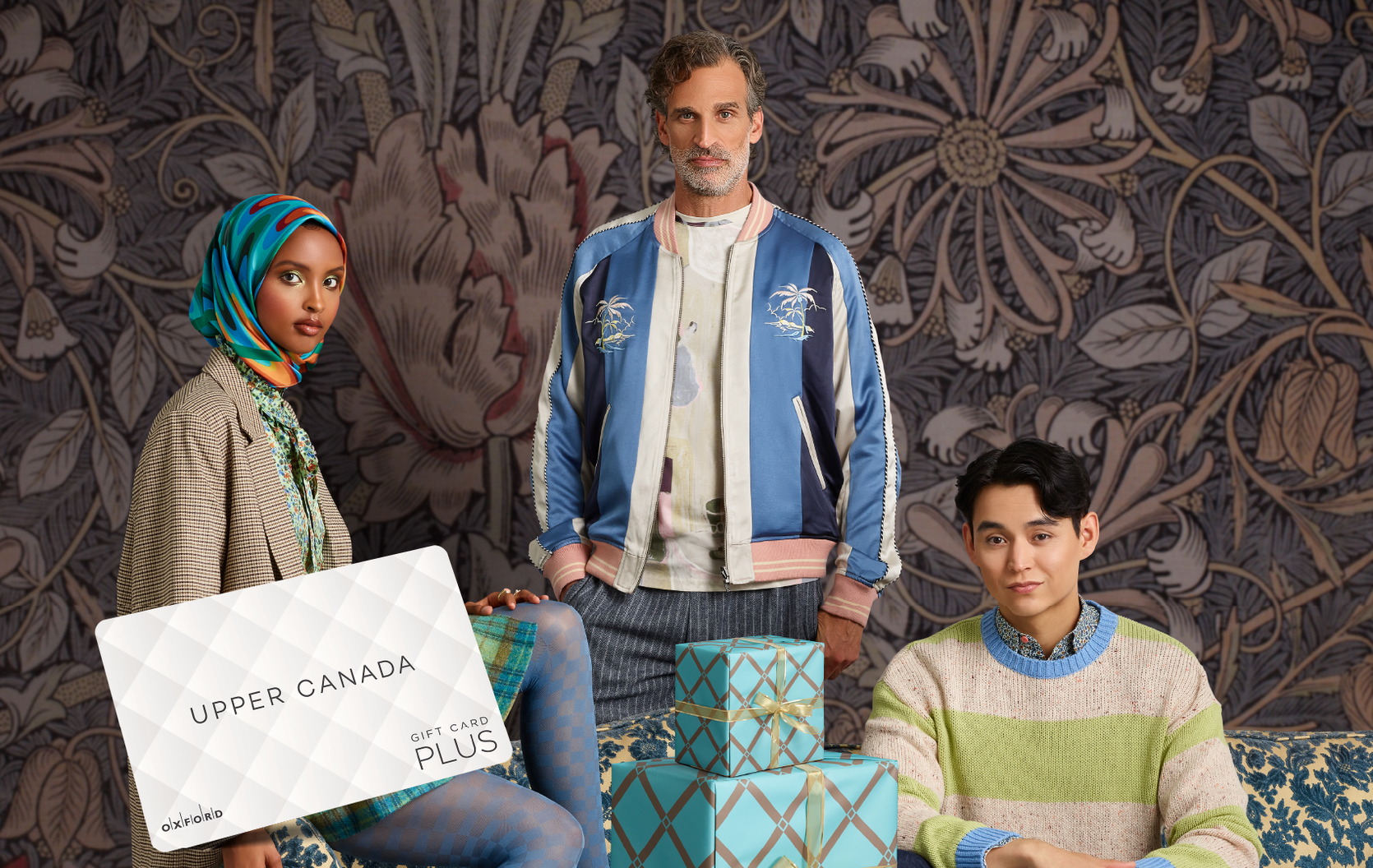 promotional image for a UCM gift card featuring three models posing against a printed backdrop