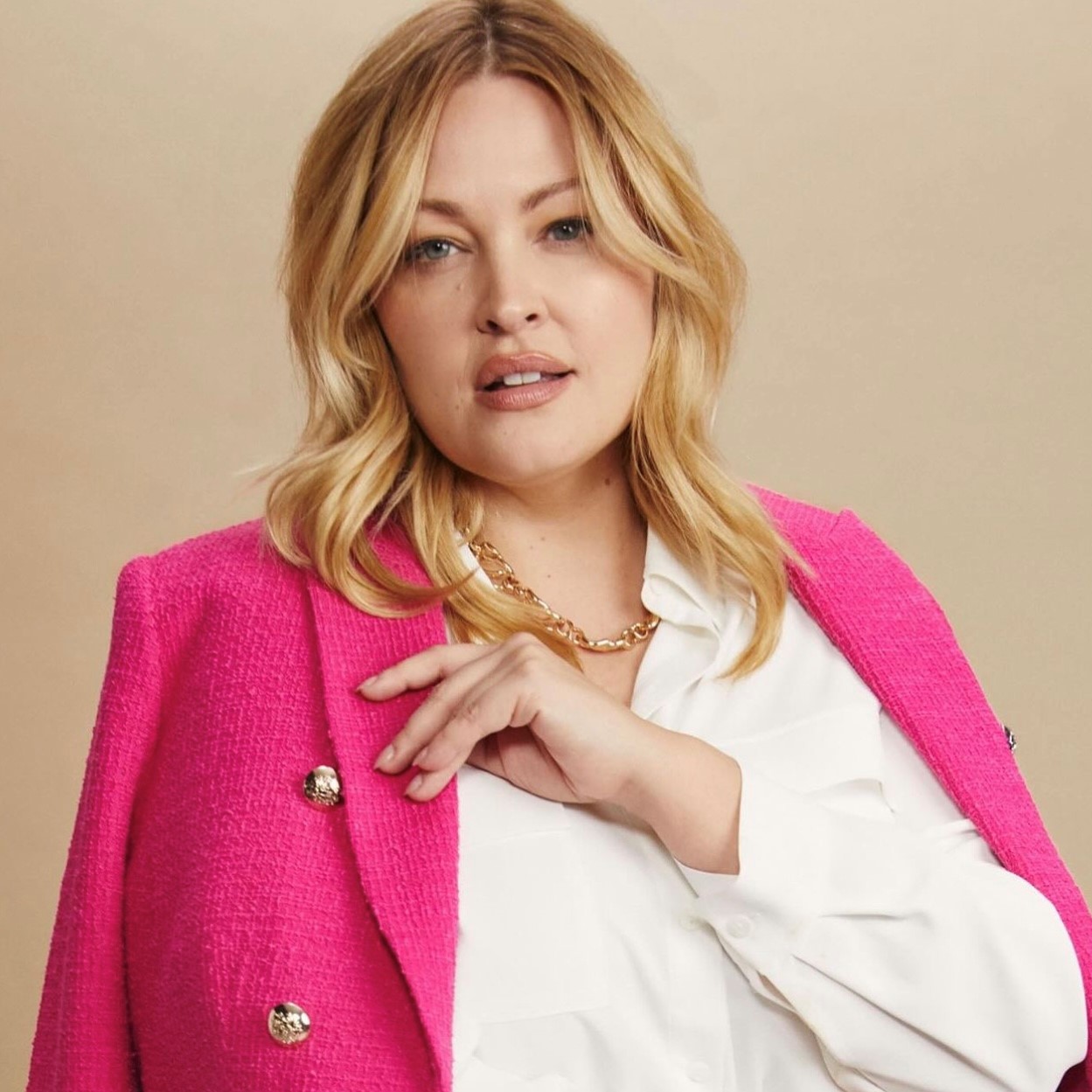 Model with white blouse and pink blazer from Laura