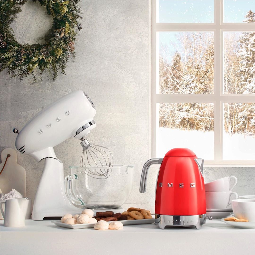 White SMEG stand mixer and red SMEG kettle on kitchen counter