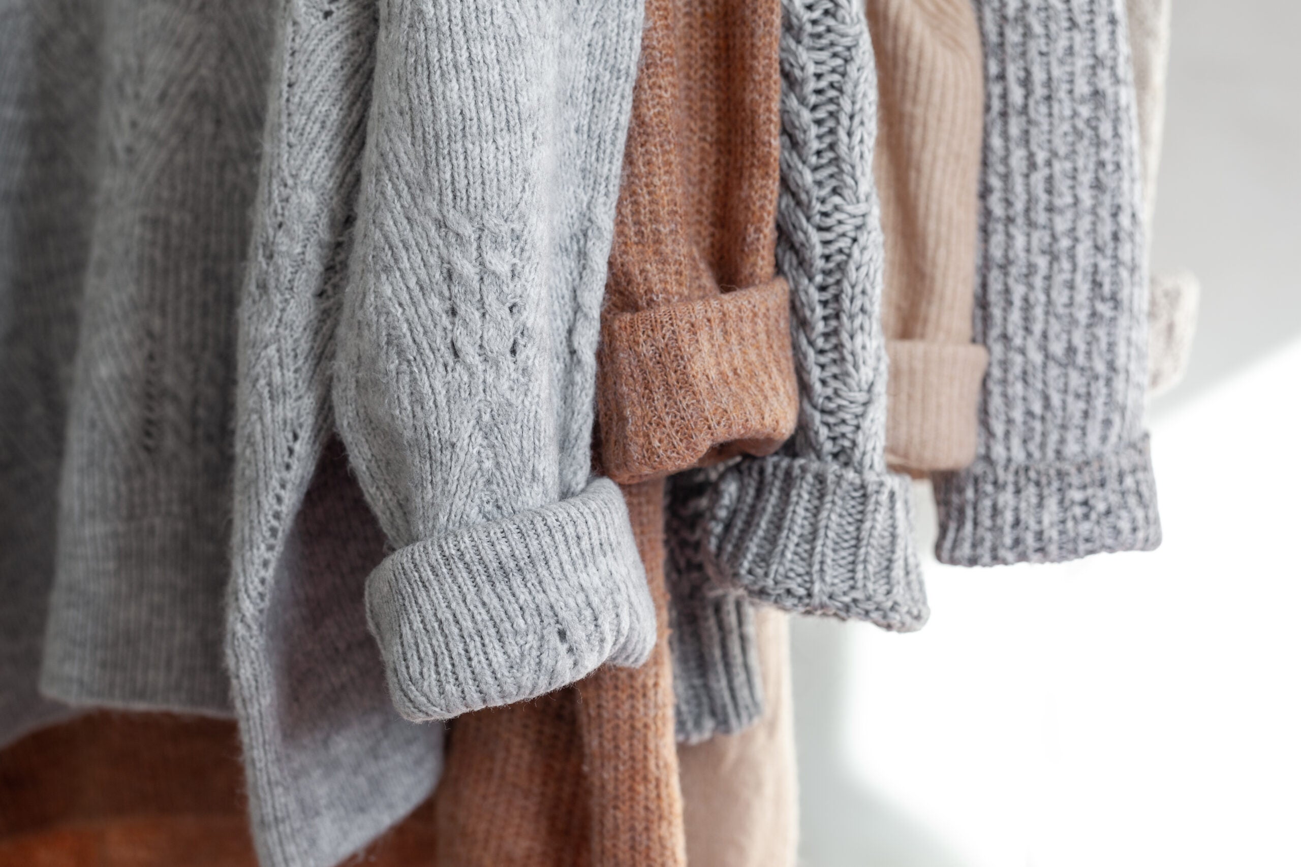 Grey and brown knit sweater sleeves