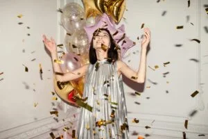 Woman Throwing Confetti With Balloons